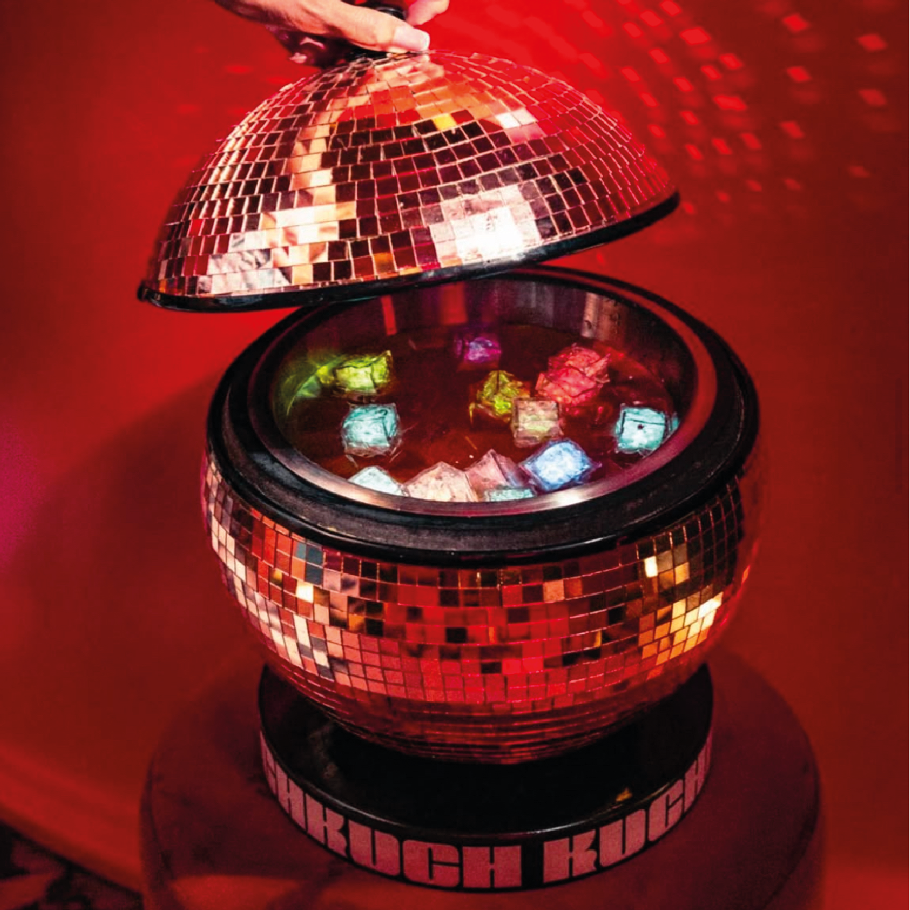 Disco ball sharing cocktail with glowing ice cubes at Kuch Kuch cocktail bar in St. Julian’s, Malta