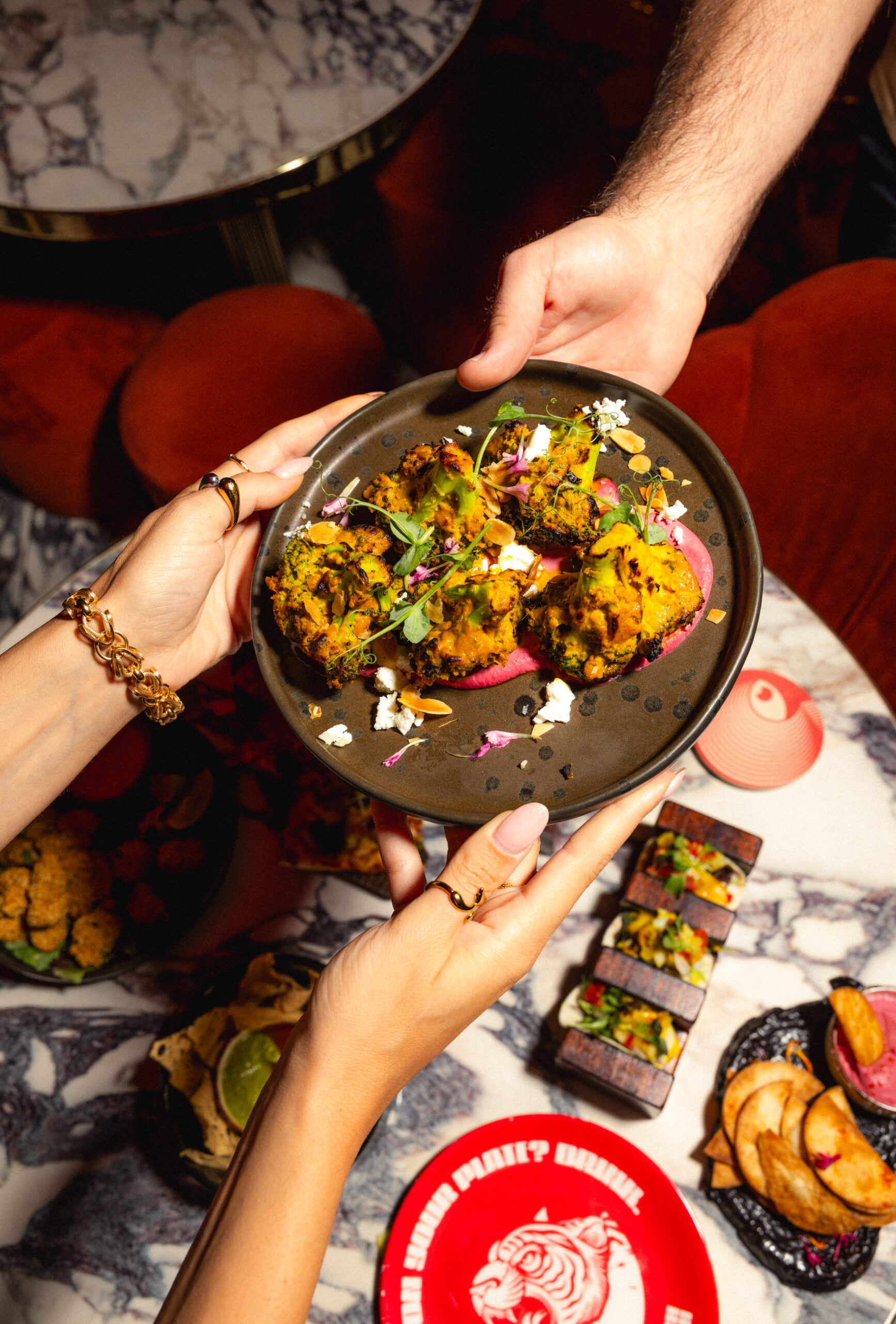 Small plates being served at Kuch Kuch, a cocktail bar in St Julian’s, Malta offering creative food, cocktails, and immersive dining experiences.