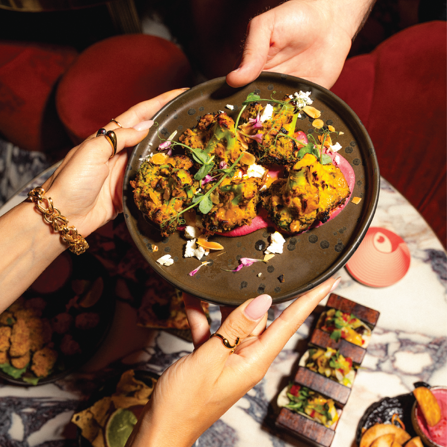Small plates being served at Kuch Kuch, a cocktail bar in St Julian’s, Malta offering creative food, cocktails, and immersive dining experiences.
